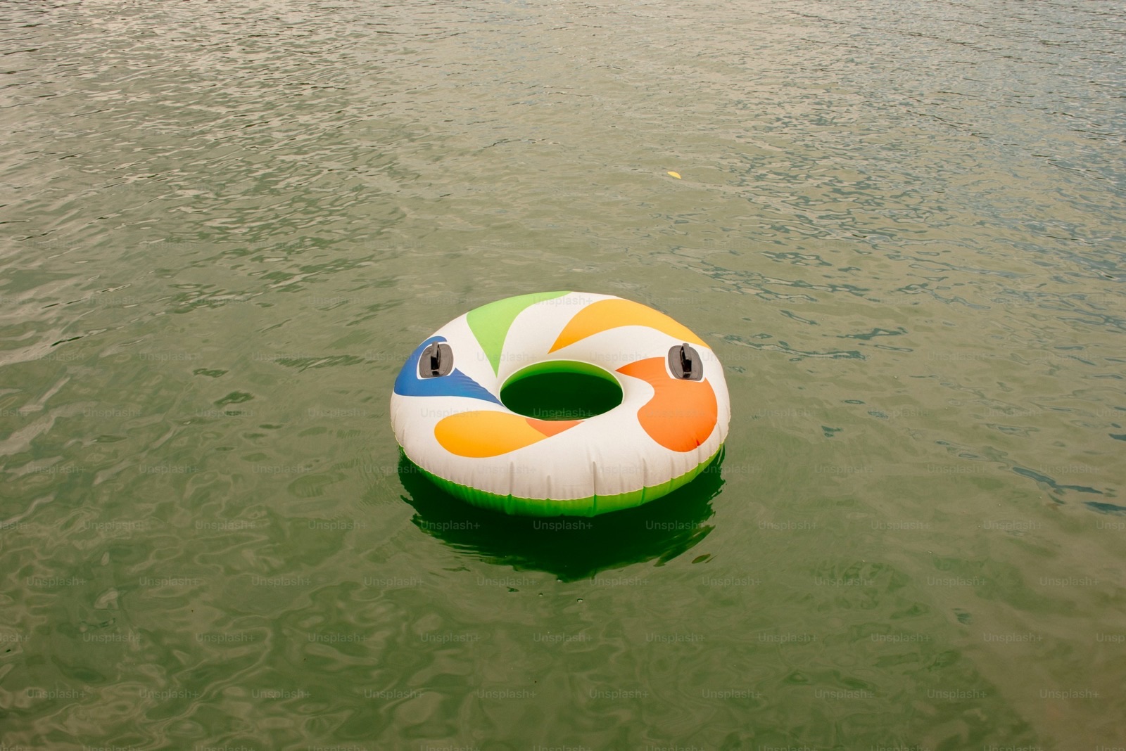 Image size 1600x900. Swimmer doing a pull set with long strokes in a lap pool.